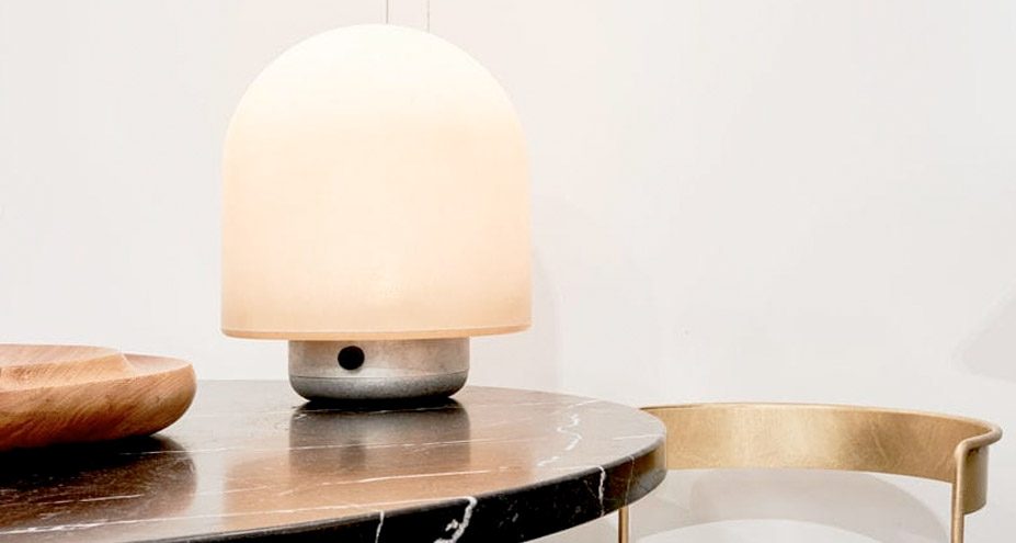 Translucent domed fibreglass lamp glowing on a marble table
